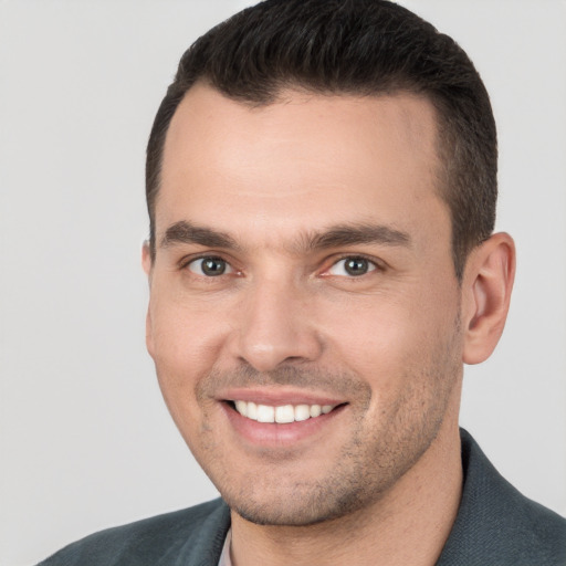 Joyful white young-adult male with short  brown hair and brown eyes