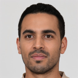 Neutral latino young-adult male with short  black hair and brown eyes