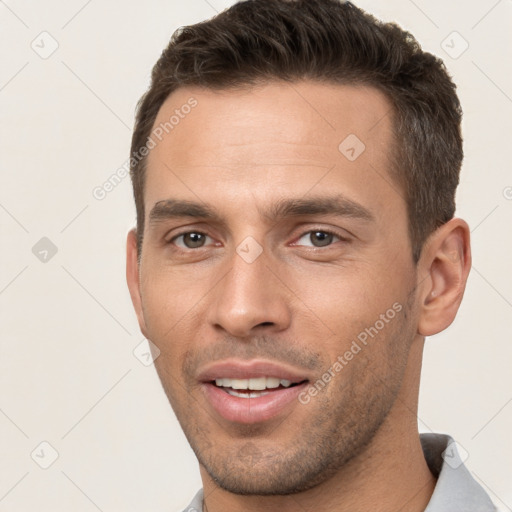 Joyful white young-adult male with short  brown hair and brown eyes