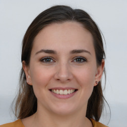 Joyful white young-adult female with medium  brown hair and brown eyes