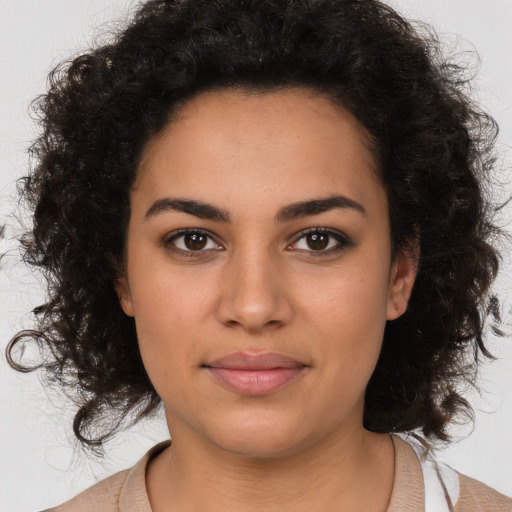 Joyful latino young-adult female with medium  brown hair and brown eyes
