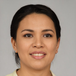 Joyful latino young-adult female with medium  brown hair and brown eyes