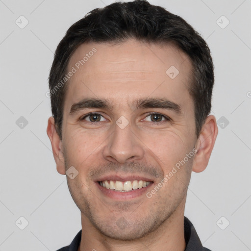 Joyful white young-adult male with short  brown hair and brown eyes