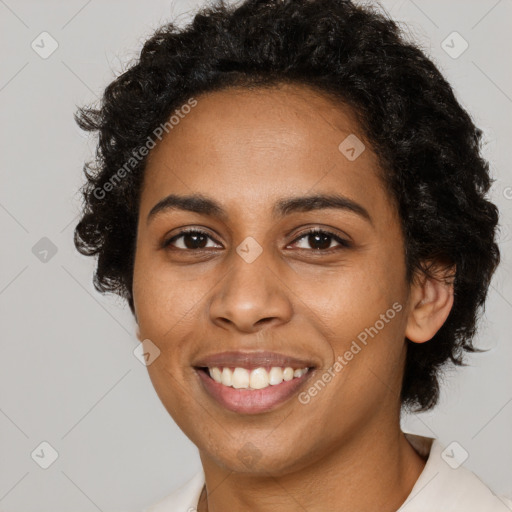 Joyful black young-adult female with short  black hair and brown eyes