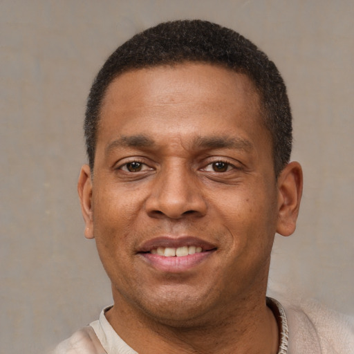 Joyful latino adult male with short  brown hair and brown eyes