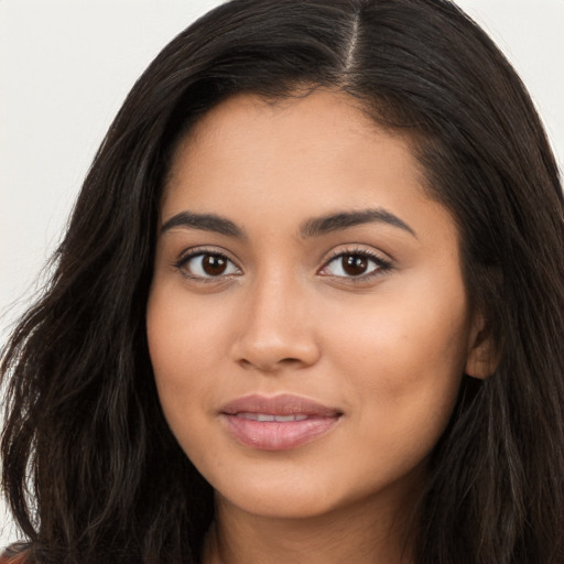 Joyful latino young-adult female with long  brown hair and brown eyes