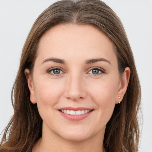 Joyful white young-adult female with long  brown hair and grey eyes