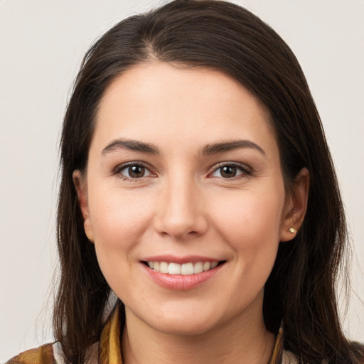 Joyful white young-adult female with long  brown hair and brown eyes