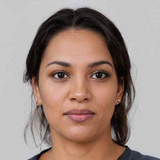 Joyful latino young-adult female with medium  brown hair and brown eyes