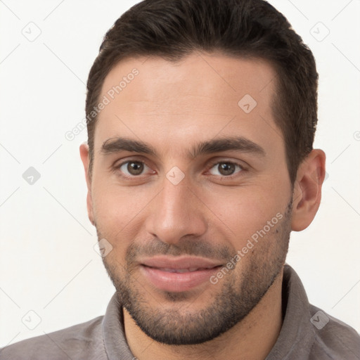 Joyful white young-adult male with short  brown hair and brown eyes