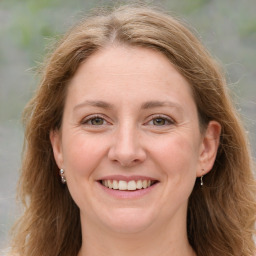 Joyful white adult female with medium  brown hair and grey eyes