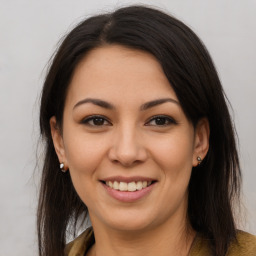 Joyful latino young-adult female with long  brown hair and brown eyes