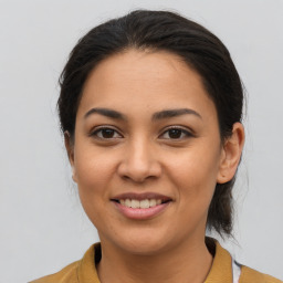 Joyful latino young-adult female with medium  brown hair and brown eyes