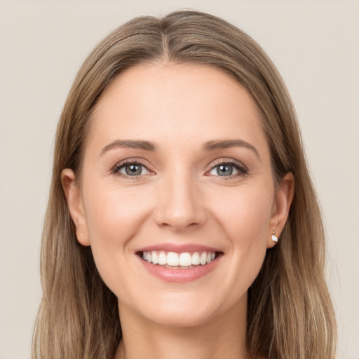 Joyful white young-adult female with long  brown hair and green eyes