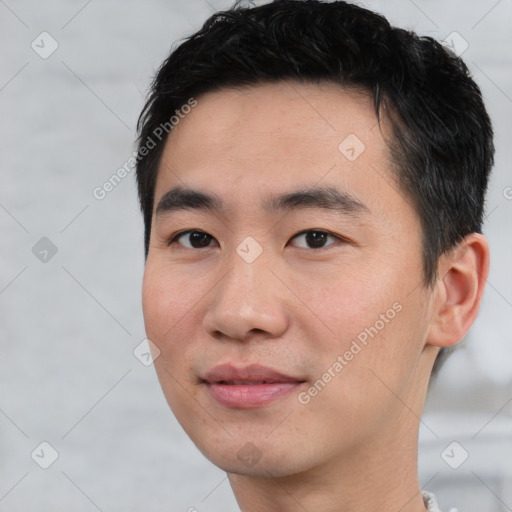 Joyful asian young-adult male with short  black hair and brown eyes