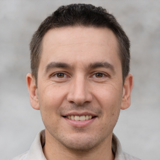 Joyful white adult male with short  brown hair and brown eyes