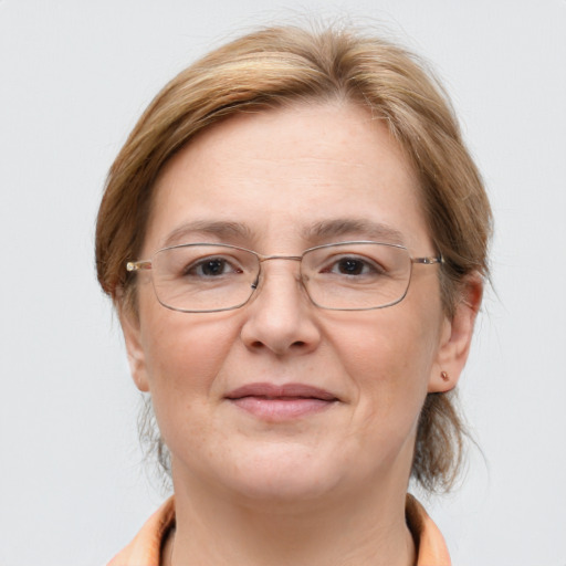 Joyful white adult female with medium  brown hair and grey eyes