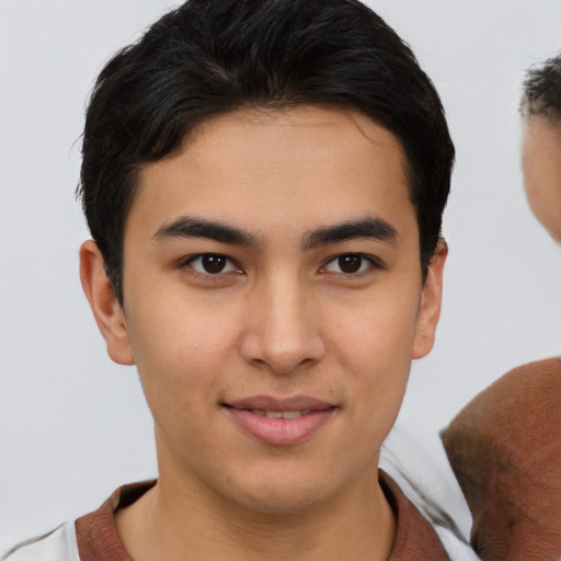 Joyful asian young-adult male with short  brown hair and brown eyes