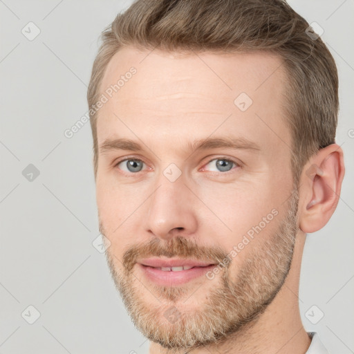 Joyful white adult male with short  brown hair and grey eyes