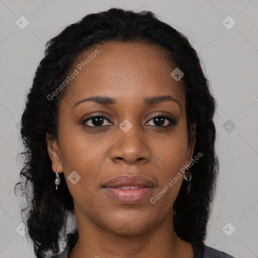 Joyful black young-adult female with long  brown hair and brown eyes