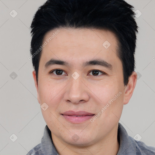 Joyful asian young-adult male with short  black hair and brown eyes