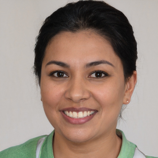 Joyful latino young-adult female with short  brown hair and brown eyes