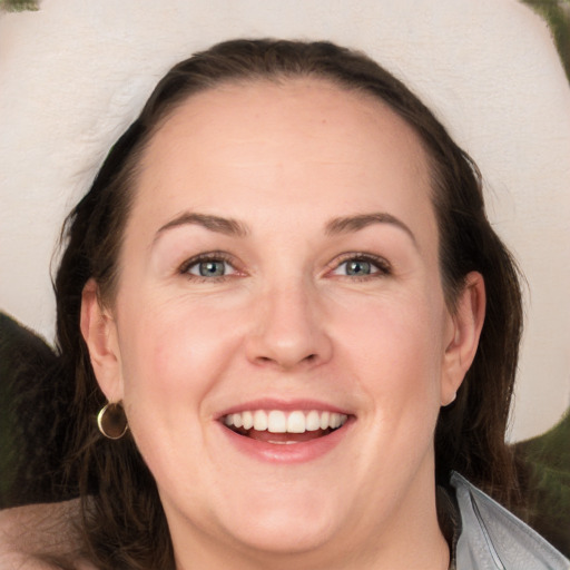 Joyful white adult female with long  brown hair and brown eyes