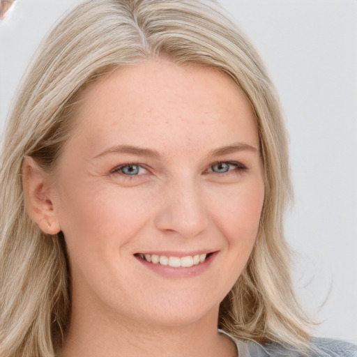 Joyful white young-adult female with long  blond hair and blue eyes