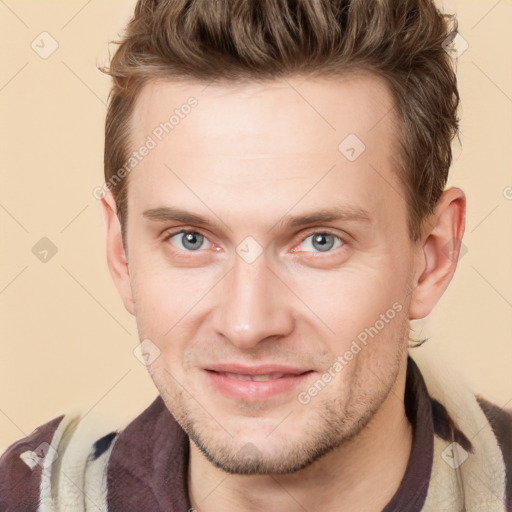 Joyful white adult male with short  brown hair and blue eyes