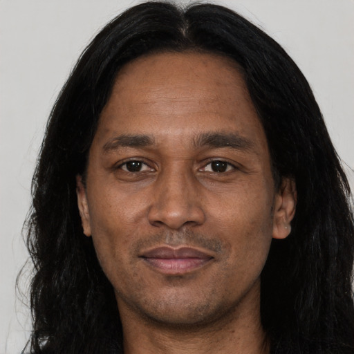 Joyful asian adult male with long  black hair and brown eyes