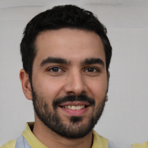 Joyful white young-adult male with short  black hair and brown eyes