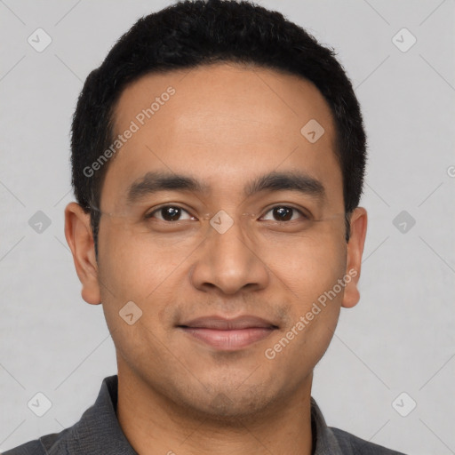 Joyful latino young-adult male with short  black hair and brown eyes