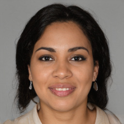 Joyful latino young-adult female with medium  brown hair and brown eyes