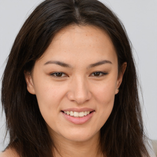 Joyful white young-adult female with long  brown hair and brown eyes