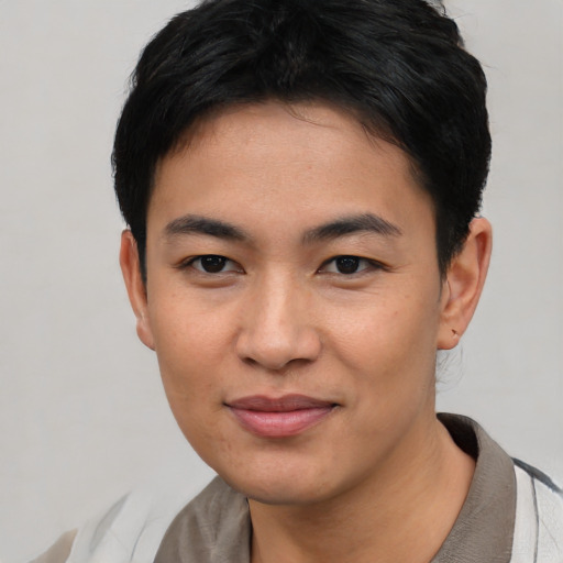Joyful asian young-adult male with short  black hair and brown eyes