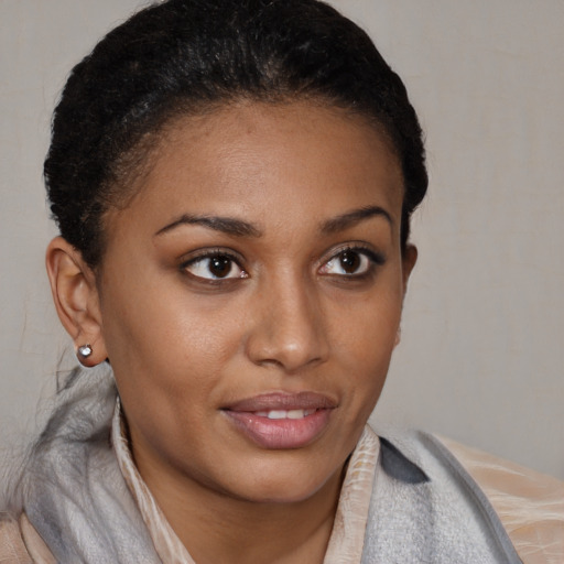 Joyful black young-adult female with short  brown hair and brown eyes