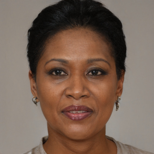 Joyful black adult female with medium  brown hair and brown eyes