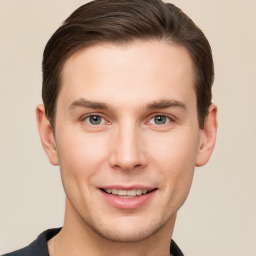 Joyful white young-adult male with short  brown hair and grey eyes