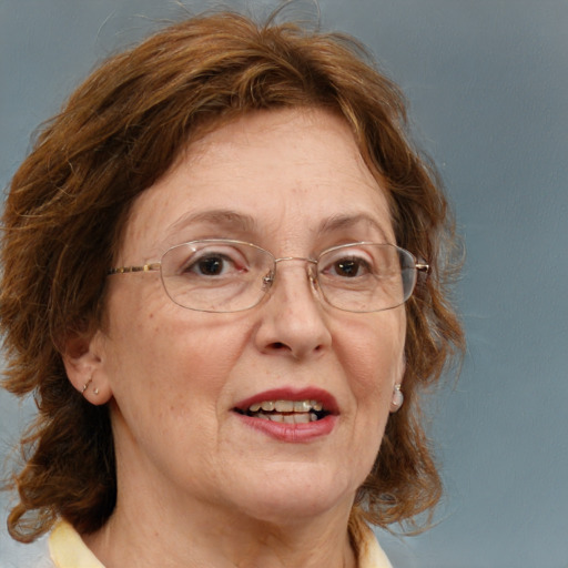 Joyful white middle-aged female with medium  brown hair and blue eyes