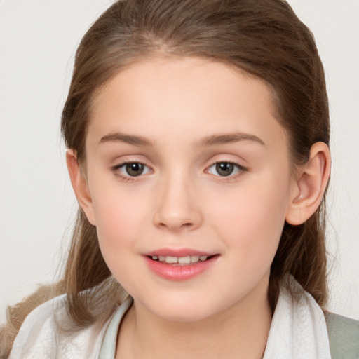 Joyful white child female with medium  brown hair and brown eyes