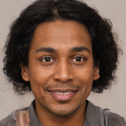 Joyful black young-adult male with short  brown hair and brown eyes