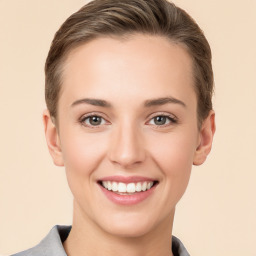 Joyful white young-adult female with medium  brown hair and grey eyes