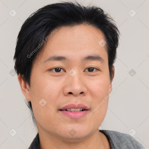 Joyful asian young-adult male with short  brown hair and brown eyes