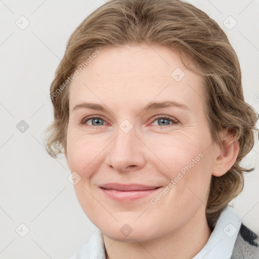 Joyful white young-adult female with medium  brown hair and blue eyes