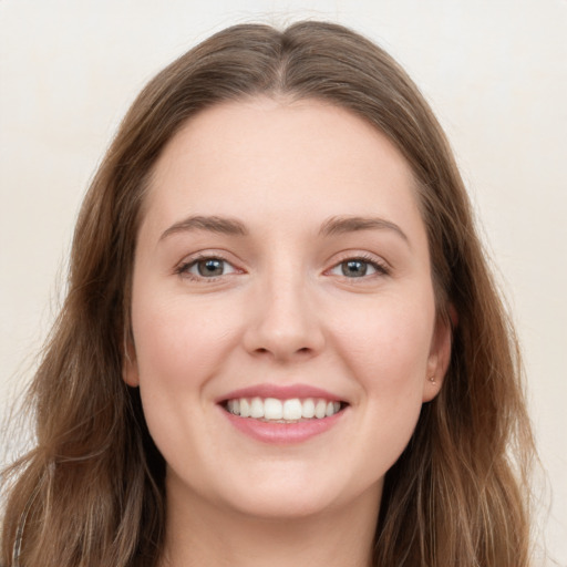 Joyful white young-adult female with long  brown hair and grey eyes