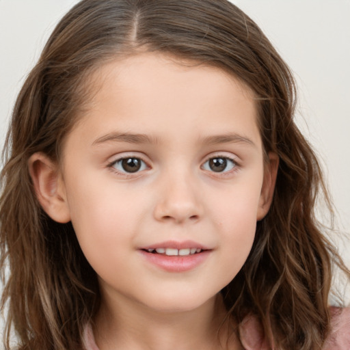 Joyful white child female with long  brown hair and brown eyes