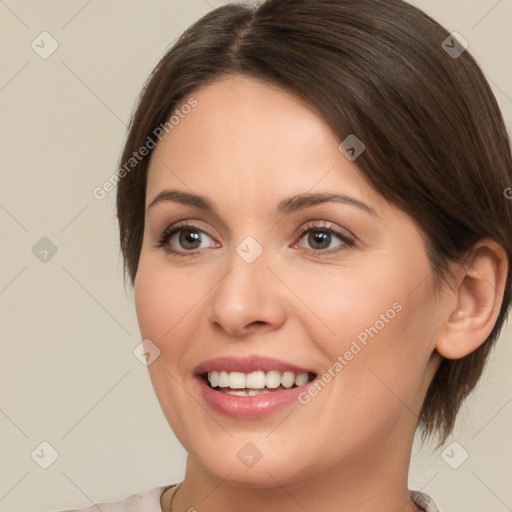 Joyful white young-adult female with medium  brown hair and brown eyes