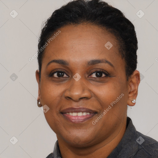 Joyful black adult female with short  black hair and brown eyes