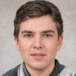 Joyful white young-adult male with short  brown hair and grey eyes