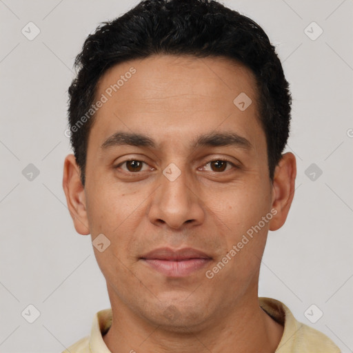 Joyful latino young-adult male with short  black hair and brown eyes